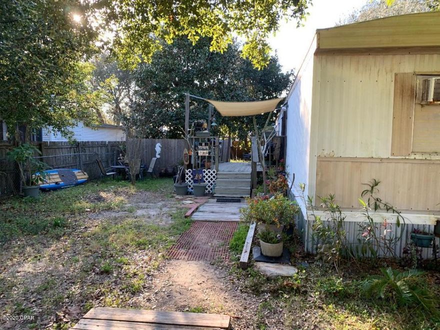 Location, location, location! Rental trailer on buildable lot. Short bike ride or stroll to the beach. Close to Pier Park, Frank Brown Park, dining and shopping. Needs some TLC