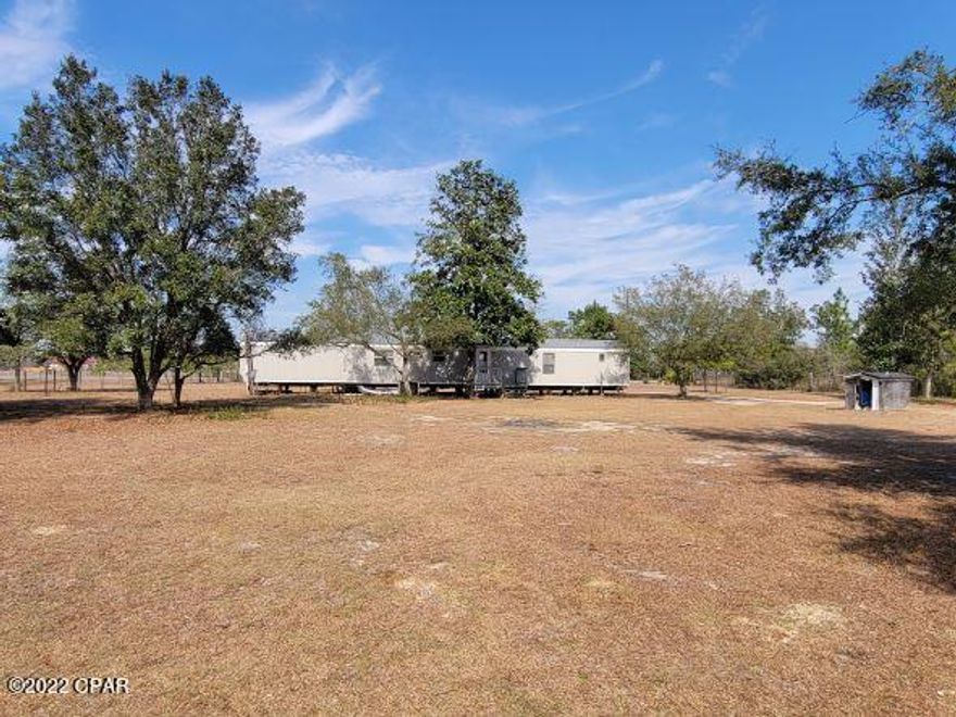 TWO Singlewide mobile homes located in a great area on 1.4 acres. This expansive lot plus two homes makes for the perfect rental situtation.  Live in one, rent the other and cover your expenses.   Both homes are in good condition and would rent extremely fast.  The front trailer is 2 beds, 2 baths and the back trailer is 3 beds, 2 baths.  Seller was renting each trailer for $300/week and it included electricity.  The area is growing and this helps fill the need for affordable housing.    40 minutes to Panama City, 30 minutes to Marianna.  Come see this property for yourself!!  Room sizes are approximate, please measure if important