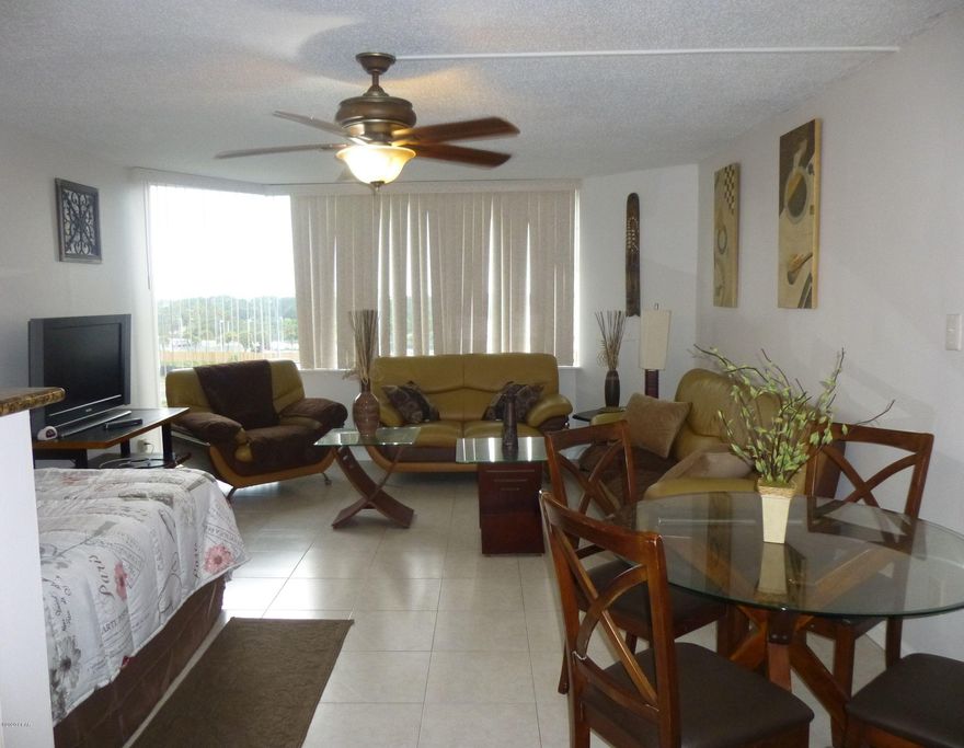 Enjoy life as if you were on vacation everyday!  Living at Top of the Gulf allows you to spend your leisure time walking on the beach at sunset, swimming in the pool, staying fit at their gym or enjoying the game room.  New windows have just been installed.  Owners are also allowed to have a pet.  This low maintenance studio condo gives you an open floor plan with 16'' tiles.  Granite counter tops and glass top stove/oven in the kitchen.  Bathroom is updated with sliding glass shower doors.  There is also a large walk in closet to give you some storage space.  Whether you are looking for a home, or a rental property to share with family & friends, this is an excellent opportunity to own a beachfront condo on the Gulf.