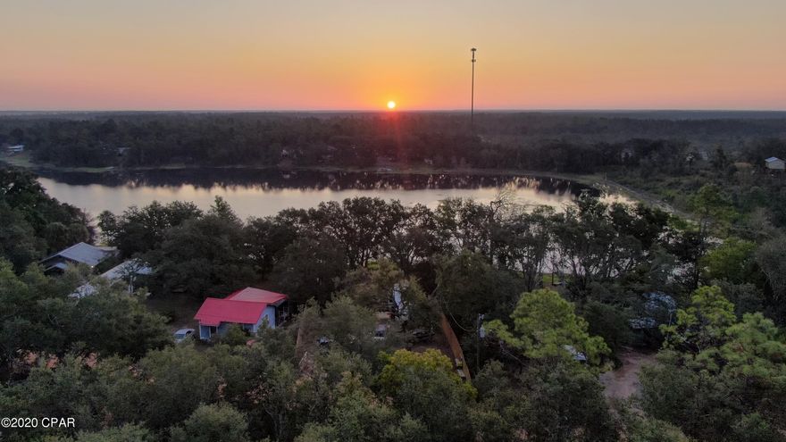 Lakefront Living!!!!! Whether you're looking for a full-time or part-time lake house, take a look at this fantastic lot on River Lake. Beautiful views, awesome fence with double gates and pillar posts with lighting at the front of the property. Lovely oak trees and sloping landscape down to the picturesque lake. Plenty of room to go big or just a small cabin will do... Minimum square footage to build is only 400 sq ft! Well & septic in place and was recently used by current owner who had a permit to have an RV on the property after Hurricane Michael. Not a drive by!! Make an appointment to see this lovely lakefront property today! (all sizes approximate and taken from public records, buyer to verify any details buyer deems important)