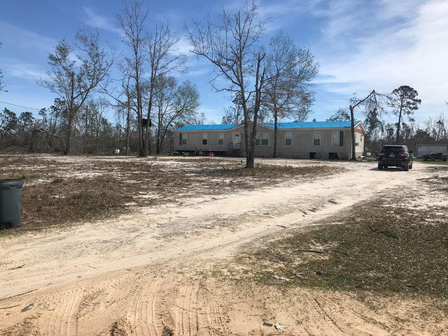 3.4 acre parcel with private well and septic tank.  There is a man-made small pond on the property. The manufactured home was totaled by insurance and is being left at the convenience of the seller.  Value is in the land only.