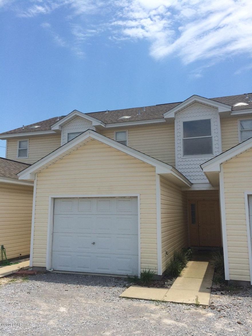 Close to the Beach!  This is a 2 bedroom, 2.5 bath townhome just a block off of the beach - close to Public Beach Access #47 .  This town home has recently been painted inside, and has new vinyl plank flooring downstairs and in the bathrooms with carpet in the bedrooms.  This unit has a one car garage, small deck/patio out back and a deck off of the master upstairs.