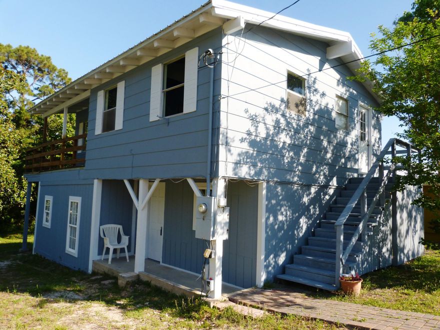 Live in one or rent the other, can even convert to single family dwelling.  Been remodeled and move in ready or complete more work doll up cute.  Can have long and short term rental in this area.  Situated on Dedicated Beach in Laguna Beach.  One bedroom/One bath up, and one/one down.  Beach house with metal roof, cute, has character, view of Lake and view of Gulf Of Mexico, stream in back flows constantly into Lake, full size lot.  What more could you ask for?  Easy to show no appt necessary. THIS IS THE LOWEST PRICE HOUSE ON THE WEST END OF PCB FOR SALE WITH A BEACH VIEW AND DEDICATED BEACH ACCESS.