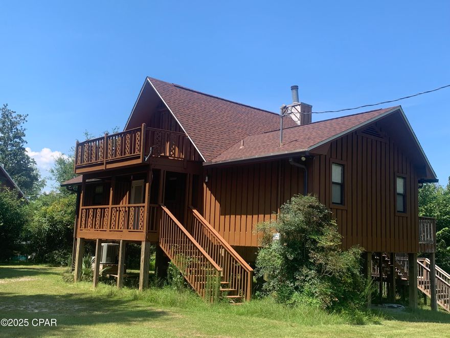 BEST & NICEST WATERFRONT DEAL IN THE USA! Just a short distance to the Forgotten Coast or PCB!
This Chipola River Waterfront Home is as nice as any you will ever find. Why? First of all, Chipola River is the nicest small river in America! Fantastic fishing! It is mostly a spring fed river and the water is really clear (unless there is a long period of heavy rain fall upriver). Yes! It is the river that flows from the Florida Caverns State Park! And it is one of the most popular rivers for canoeing & kayaking & tubing! The 1492 HVAC home is really immaculate! The 2 bedrooms is easily converted to a 3 bedroom, as the upstairs is an easy conversion to a THREE BEDROOM (only reason for not calling it a 3 bedroom is the included closet is a nice large shift robe which is not a built-in closet.)  In fact, it already is 3 bedrooms for all practical purposes! The upstairs fully finished room  (3rd bedroom or game room) is 14 feet X 23 feet! Huge! And get this, it has double doors that open to a BALCONY that is 16 feet X 8 feet! The downstairs interior is totally awesome gorgeous and has an enormous amount of rare PECKY CYPRESS! Pecky Cypress is basically unobtainable anymore as it is cypress wood that was underwater for many-many years where it obtained it's unique-rare-unmatched-beauty!
The exterior siding is cypress wood, which is highly resistant to insects or rot (WDO) resistant more than about any other type of wood! It is built up high on 12''x12' pressure treated pilings and is above the level (the first interior floor) where any high water (flood level) has ever been since it's construction over 30 years ago. This lot is one of the highest elevations on the entire Chipola River waterfront! The great room is fantastic and overlooks the river and has a beautiful fireplace! It too is ordained by that rare Pecky Cypress! There is too much here to describe. There is a grape arbor on this huge-basically one acre lot! 131 Feet of River Frontage! Nice homes in the area and across the river! Oh, you are right! IT WOULD MAKE A HIGH DEMAND B&B! Whether a vacation get-a-way or your retirement home or your DREAM HOME ON THE RIVER this one is IT!
It HAS THREE DECKS that run together that overlook the river: TWO 8'x12' decks and the middle deck is 12'x20'!!! 432 square feet of open deck on the river! And it has 640 square feet of stand-up high space below the first floor for shop space or storage or even room to garage a car! The space under the house has a floor that is made of 2''x6'' Pressure Treated wood!  Yes!  You can entertain all your friends all at once! And, yes, the large master bedroom has a really nice full bathroom! Come see. But don't wait. It will not last.