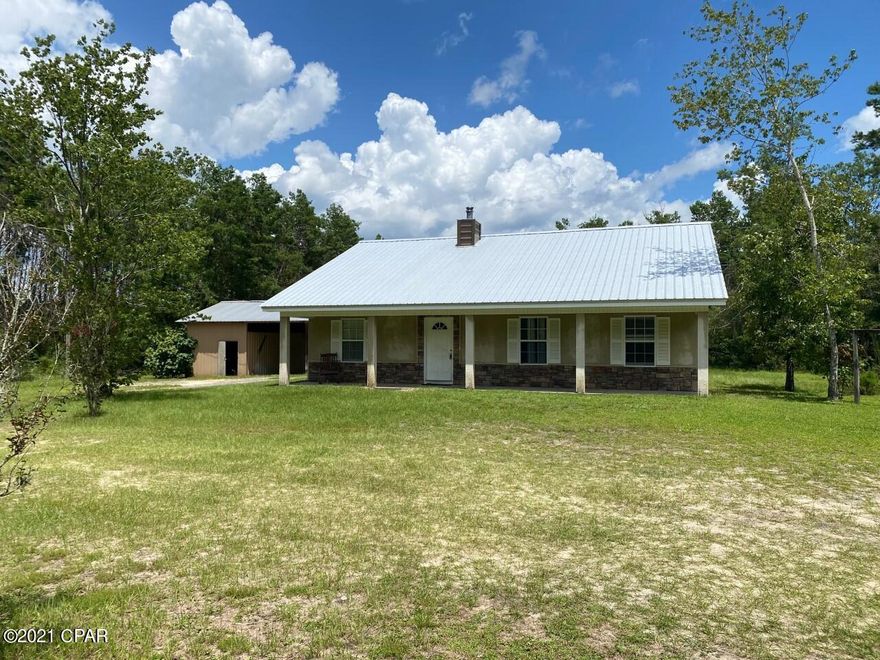 Great home in North Bay County located in Southport. This home sits on 3 acres of land (mostly maintained by the Landlord) to include a circular drive way, covered carport with enclosed storage building.  This home features a split bedroom floor plan with cathedral ceiling in the living room with a wood burning stove, lvp flooring, and breakfast bar.  Also features a separate office and sitting area.
