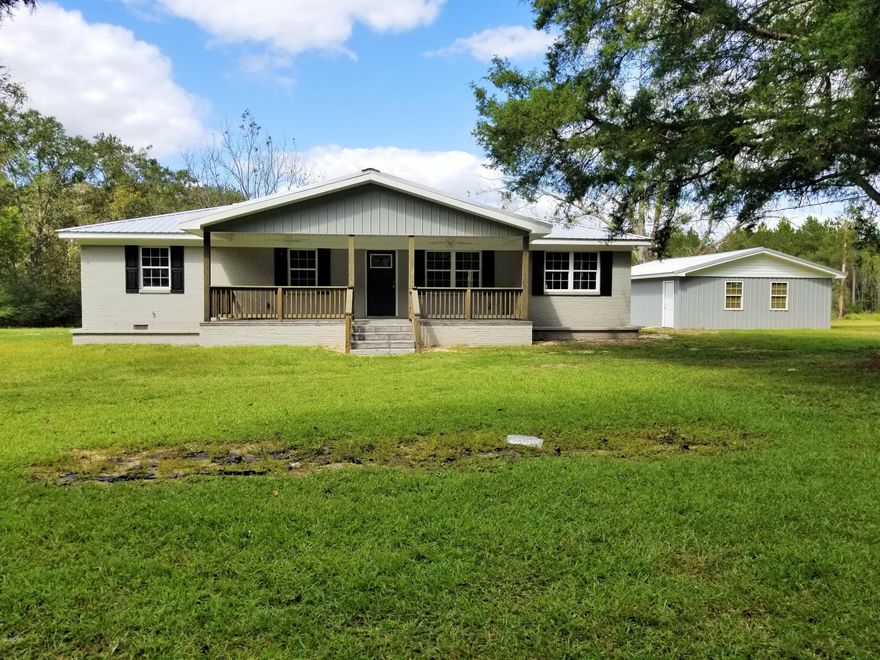 This amazing newly remodeled home def has that WOW effect when you enter the large open living room, dining room and kitchen area. This three bedroom and two bath home sits on FOUR acres and has a pond full of fish on the property.  There is a nice outbuilding that is having a new roof and siding installed.  Here are some of the things that have been done to the home. New metal roof, paint, 50 gal water heater, granite counter tops, all new cabinets, walls and ceilings have spray foam insulation, beautiful upgraded hardwood floors, 2.5 ton ac/heat, septic system, windows, doors, granitecrete on the front porch.  Large master bedroom comes with a large walk-in closet and master bath has a beautiful tiled walk-in shower.  Stainless steel appliances. Everything is under warranty. Call toda