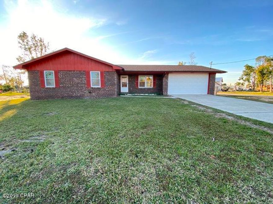 Sturdy brick home on a huge corner lot close to the Bay in the desirable Lynn Haven neighborhood. Home features  engineered wood floors in  the spacious living room, hall, and bedrooms. There is tile in wet areas, kitchen, dining area, laundry room and bathrooms. No carpet! The kitchen is galley style and eat in. There is extra room for a small workshop in the oversized, two car garage. The windows appear updated as does the roof. We have installed a new garage door on the home and have cleared and leveled the lot post hurricane Michael. We have located some affordable private flood insurance for this VE zone it is attached for agents to access and is applicable for owner occupants,  investor rates may be different on the insurance