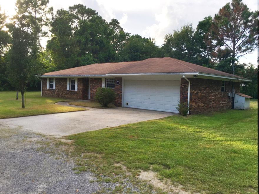 Country living in the heart of the city! This 3 bedroom, 2 bath brick home is on almost an acre of land, surrounded by trees and tucked away on a dead end street. You even have fresh water from the well! Parking abounds with a 2 car garage and pole barn. The interior of the home was  completely updated a few years ago. Laminate floors grace the large, open living area. The living room has a large brick fireplace with  French doors that lead out to the screened in brick patio. The large eat in kitchen opens to the living room and has plenty of cabinets and counter space, hard surface countertops and stone backsplash. One of the bathrooms has a step in shower. All this and the convenience of having everything you need just down the street!