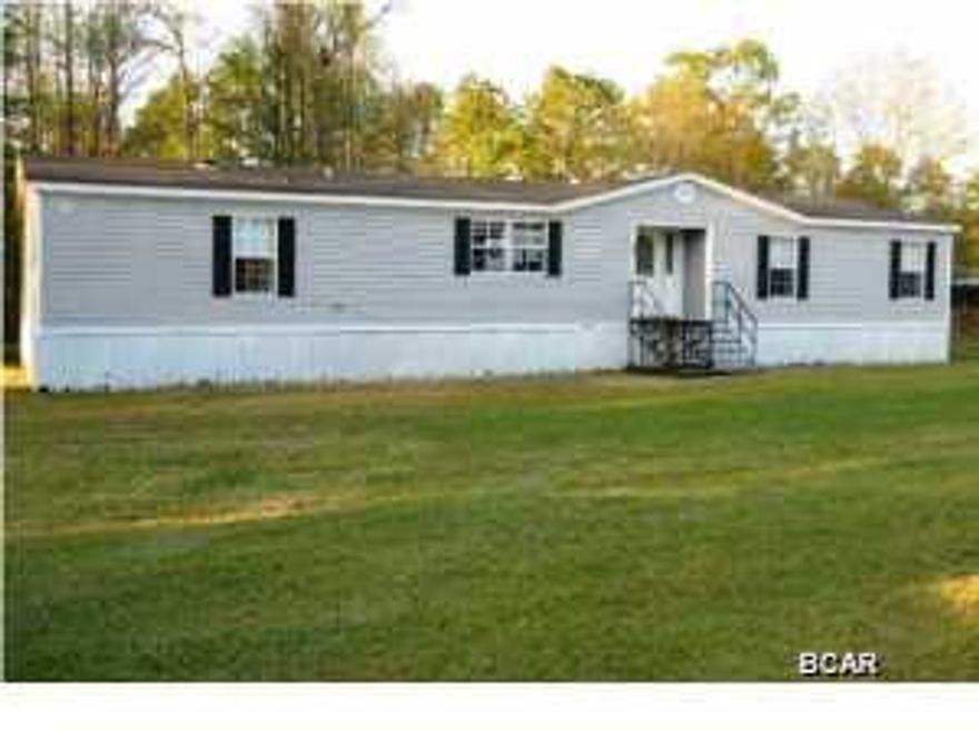 This is a Mobile Home that you wouldn't want to pass up seeing. Immaculate and nestled in on 1+ acre of land. You will be impressed and feel right at home from the time you walk in the door. Open floor plan that features amazing kitchen with decorative faux brick touches, tons of cabinets, counter space, breakfast bar and island. Cozy up by the corner wood burning fireplace in the living room. Large bedrooms. Relaxing garden tub, separate shower and double vanities in master bath. Walk In closet is every girl's dream. Spacious laundry room with built in cabinets. Step out back and enjoy sitting on the covered back porch and looking at a serene setting which feels like you are in the woods but are only minutes from town. Call today for more information!