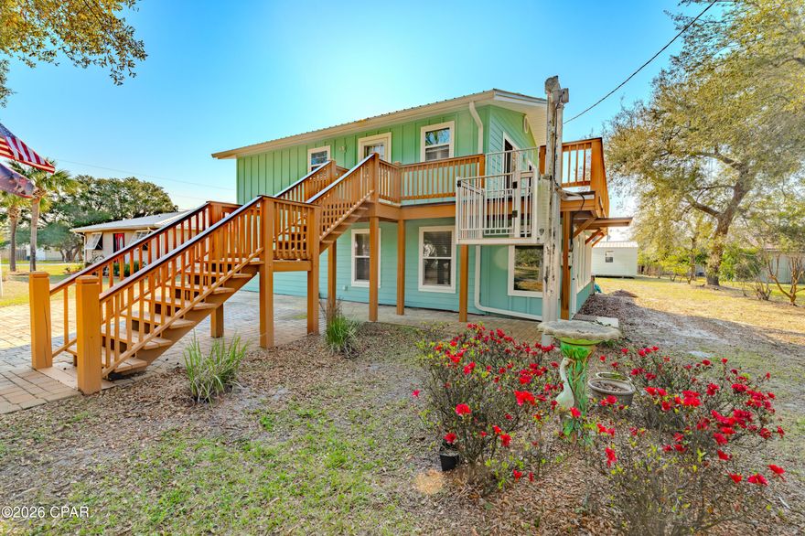 Discover the perfect blend of coastal living and income potential in this beautifully maintained home just steps from the beach in Port St. Joe!

This 2,048 sq ft heated and cooled property features two fully self-contained units, each offering 2 bedrooms, 2 bathrooms, full kitchens, and spacious living areas--ideal for short-term rentals, long-term income, or multi-generational living. Live in one unit and rent the other, or maximize returns by renting both!

Situated less than two blocks (approximately 300 yards) from the beach, you'll enjoy quick and easy access via a dedicated beach access at the end of the street.

The downstairs unit includes a fully enclosed sunroom, perfect for relaxing year-round, while the upstairs boasts a spacious deck with beautiful views. Accessibility is a standout feature, with a $10,000+ exterior lift providing easy access to the upper level.

Recent updates and highlights include:

New roof (2019)
Durable Hardie board siding
Whole-home generator
Updated paver driveway and walkways
Two 12x20 metal storage sheds

Located just outside the flood zone (no flood insurance required)

The property is framed by stunning oak trees, giving it incredible curb appeal and a true coastal charm.

Whether you're searching for a primary residence, vacation home, or income-producing property, this one checks all the boxes.

Don't miss your opportunity to own a versatile beachside property with built-in income potential--schedule your showing today!