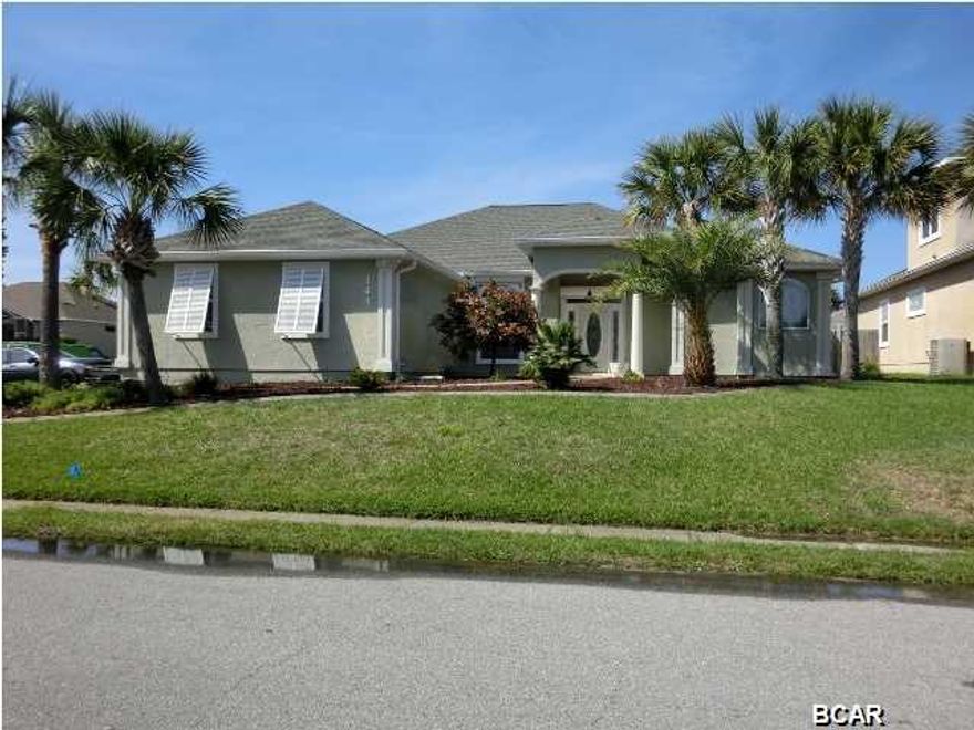 WOW! PRICE REDUCED! SUMMER BREEZE community on the west end of PCB. VERY spacious corner lot home with side entry double garage, low maintenance landscaped beds, SOLAR HEATED IN GROUND POOL! Electric Hurricane Window Shutters along back side of house, Almost maintenance free back yard. Back yard fully fenced with gate door, Back yard is mostly hard surface...perfect for entertaining and cooking out! Plenty of privacy space to lounge, swim and cook! Stroll from the pool right into the SunRoom and enjoy a refreshment from your Summer Kitchen! SunRoom is 26' x 10', gourmet kitchen has gas range, Stainless appliances, side by side frig is less than a year old and this fabulous kitchen also has a built in wall oven, perfect when cooking for larger groups! Granite counters in kitchen, very large center island with granite counter including storage cabinets with pull out tray drawers! Cabinets were custom made with a high shiny white finish-very nice, some glass paneled cabinets as well. Super large pantry cabinet with tons of storage! This kitchen does not lack for cabinet and drawers! If you need another place to hang out there is a separate formal living room area with double paned glass doors that connect to the SunRoom. Master Bedroom suite is located behind two sets of double paned glass doors conveniently located entirely on the east side of this home, Double vanity Master Bath features a huge walk in tiled shower and a separate whirlpool tub (added in 2013). West side of home boasts 3 good sized bedrooms, one Jack -n-Jill full bathroom and a third full bathroom is perfectly positioned to be used a pool bath too! Surround sound speakers throughout house and outside on patio, well on site for sprinklers. Exterior was painted with Elastomeric paint.  (all information including room measurements contained herein is to be verified by Buyer/s).
