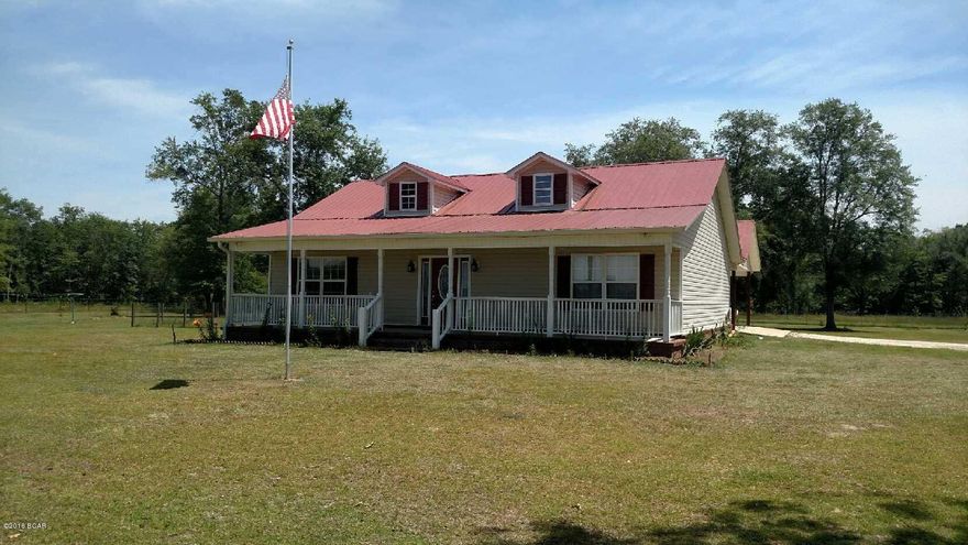 Bring your cows & horses .. 24.55 acres that is fenced & cross fenced. Pond on property. Home is inviting with the large-rocking chair front porch, red metal roof, and vinyl exterior. Home has 3 bedrooms and 2 baths. master suite features a jacuzzi tub, tile walkin shower & double vanities. Living room has 10 ft. trey ceilings. Kitchen has stainless steel appliances & beautiful cabinets.  Other features of property include: attached carport with concrete slab, private drive, 5 stall polebarn with plenty of room to store equipment or toys, and enclosed shop on concrete slab, water & electric. Home is in move in condition.