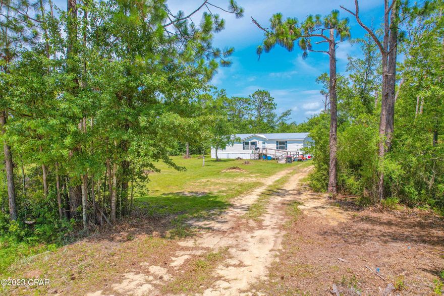 Back on the Market.  Minutes from Highway 2302 and near Southport Elementary School.   A 3 bed 2 bath double wide sitting on a large 1 acre tract.  Plenty of exterior room to roam around and abundance of privacy.  Home is a 2001 with a Front Porch Deck.  Interior of home features a formal dinning room, large living room and kitchen.  Extra room for your washer and drier hook up.  You have a split bedrooms with Master bedroom on one side of the home and guest room on the other side.  Utilities incorporates a Well and Septic and new metal roof.  Great location close to Lynn Haven and in the Southport area.
