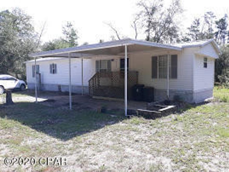 Newly remodeled mobile home nestled among the woods but right off Hwy 77 too.  Mostly wooded property but has an open yard around home.  Home has a large living room open to the kitchen.  2 good-sized bedrooms. Rrenovations include:  New painted ceilings, walls, doors & trim, new tile flooring throughout the home (no carpet), new light fixtures & ceiling fans, new stove & range hood, new toilet, and more.  Metal roof over home.  Big covered patio in front of home and small covered back porch.  Storage shed in yard.  All electric home.  Very close to daycare facility and convenient to Bozeman School.  Long gated driveway to home.  Pls call for an appointment to see - Do not enter without an appt.  Owner/Broker.