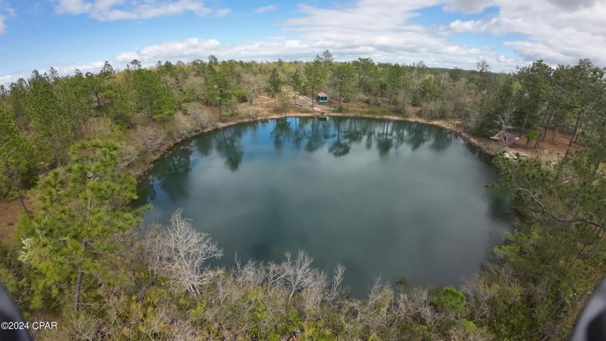 If your looking for your own slice of paradise - you just found it!  This GORGEOUS 2 acre piece of paradise is only a few miles north of Compass Lake, with it's restaurants and plentiful recreational water activities - but you have your own access to a crystal clear springfed pond that is the BEST swimming hole you ever dreamed of with over 400ft of pond frontage.  This property also comes with a camping shed with a large screened outdoor living area, picnic table, fire-pit area that awaits your best camping memories this summer!  RV parking pad also on property.  Property is located inside of the Compass Lake HOA, which is OPTIONAL at $135 year, but gives you access to their pool, frisbee golf, and other recreational activities just 2.4 miles away (as the crow flies).  This area is in a prime location for future development and appreciation, but for now, your privacy, peace and quiet will be PRICELESS.