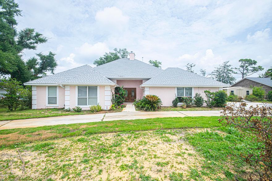 Tucked away overlooking Lake Hentz and Pretty Bayou, this 2600+ square foot 3 bedroom 3 1/2 bath home offers light filled spaces, high ceilings, and privacy.  Living room features a gas fireplace, built in bookcases, cabinetry, and crown moulding. Newly renovated kitchen features spacious granite counter tops and subway tile back splash.  Desired split floor plan features two separate wings for the home.  Bedroom sizes are huge compared to today's new construction homes and with 10'-12' ceilings, home feels even more spacious. Master bathroom was recently renovated with granite vanities and re-tiled shower.  Large kitchen is adjacent to breakfast nook, and formal dining room features hardwood flooring.  Abundant storage throughout the home. Owner Financing available to qualified buyer. Abundant storage throughout the home with large oversized walk-in closetsin every room, pantry, and even a huge storage closet in the over-sized garage, French doors open to huge lot and 200 sf back deck with water views. Roof was replaced in 2019 with warranty.This home offers two HVAC's (2019/2008), two water heaters,  one electric and one gas.  Elevation certificate showing home is not in a flood zone, is available as is a wind mitigation report on the roof, and a survey.  Back deck is made by a dock builder using TREK "forever wood", and lovely deck oak tree was deemed healthy by Gulf Coast Trees.  Large circular driveway, yard shed, and even room for your RV to park makes this home one for today's lifestyle.  Oversized garage has 18' wide door.  Front and back yard are in the process of being re-sodded. Irrigation is on a well.   Owner financing is available, but traditional preferred.  Make your appointment to see this home today!