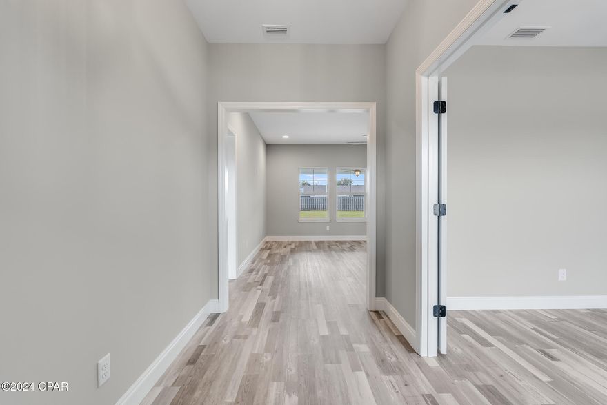 ***Currently under contract, seller accepting backup offers. NEW CONSTRUCTION 3 BEDROOM(WITH BONUS ROOM/OFFICE), 2 BATHROOM HOME IN LYNN HAVEN'S DERBY WOODS SUBDIVISION*** This beautiful corner lot home on an oversized lot leaves nothing to be desired!! Features include vinyl plank flooring and gorgeous tile throughout, quartz countertops, black stainless appliances, deep farmhouse kitchen sink, top of the line lighting fixtures and ceiling fans, mudroom, and one of the largest laundry rooms you will find for a home in this price range. The covered porch is huge and would be a wonderful outdoor living area if screened in. There is a separate well pump for the sprinklers and the back yard is large enough for a pool with plenty of green space left to run around in. The backyard is completely enclosed by a 6 foot fence for maximum privacy. All information is approximate and should be verified by buyers if important