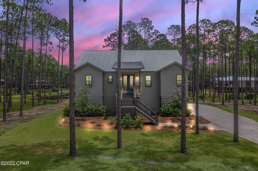 CURRENTLY UNDER CONTRACT, SELLER ACCEPTING BACKUP OFFERS. Spectacular 3400 sq. ft. 2020 built home offers four bedrooms, three baths and a half bath, a loft area, an office/flex room, an oversized screened-in porch, and three car garage. This home has special upgraded features: Electrolux and Thermador Professional appliances, a generator, custom trim throughout the house, a well for irrigation, and a Legacy lift.  This home is in Panama City Beach's most exciting, fast-growing premier gated community. This community is designed for those who love nature and many different activities. At RiverCamps, you will enjoy boating, fishing, paddle boarding, crabbing, and hiking on a 7-mile nature trail system. RiverCamps on Crooked Creek offers an onsite boat ramp and boat storage.