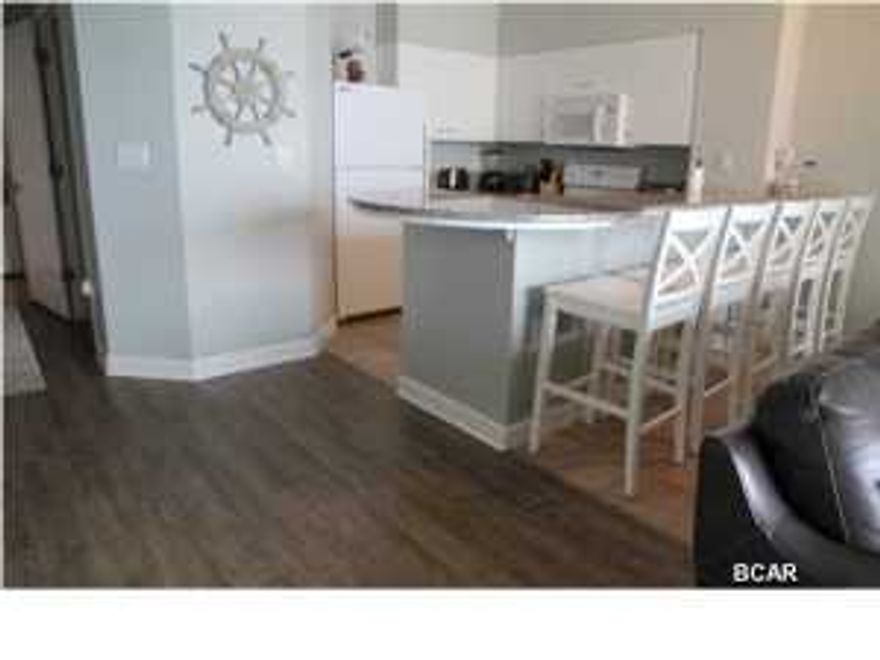 LOWER LEVEL ''L'' floorplan. INCLUDES A 6th FLOOR PARKING SPACE. Fully Furnished and rental ready. BRAND NEW LUXURY VINYL FLOORING INSTALLED. This is the ''20'' stack where both the master bedroom and the living room have a wall of windows and sliding glass doors looking directly out at the Gulf of Mexico. EXTRA LARGE BALCONY. It really should be considered a 3bd because the Bunkroom is HUGE and has a separate door and it's own 1/2 bathroom. Shores of Panama is an excellent location on the beach next to Pineapple Willy's and is within walking distance of other restaurants and entertainment. A resort unlike any other with beautiful exterior details and impressive modern architecture. It is Panama City's ultimate vacation destination with multi-million dollar amenities: huge lagoo