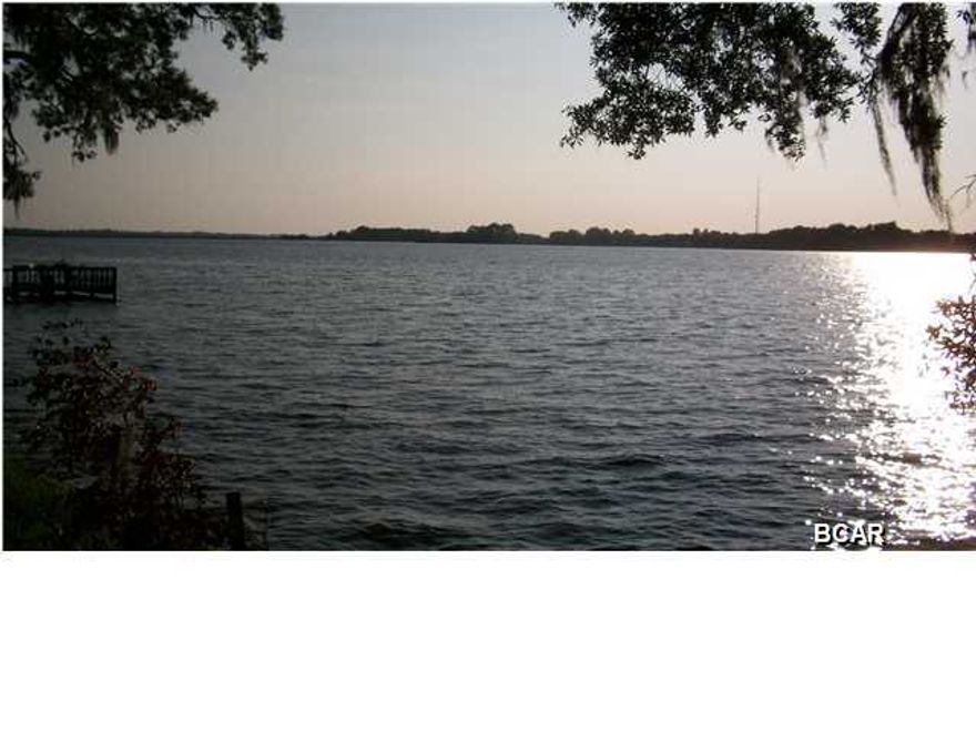 Georgeous Waterfront lot on Deerpoint Lake with over 1.28 acres. This long held family land is now available and offer 146 feet of deepwater frontage with unobstructed lakeview, no marsh, no muck. Convenient location just off Highpoint Road. Paved County road turns into private road This is a high and dry lot with high elevation, a seawall, and according to the owner has never flooded. Large pretty oak and magnolia trees and good neighbors help make this a perfect lot to build your dream home on. The lot has a capped well on it. Underground electric and restrictive covenants help make this appealing as a perfect lakefront homesite. A deep well and septic tank are required. Fish, boat, and swim in your backyard and watch unobstructed sunsets 365-days a year. All things considered, this is probablly the finest lot for sale on Deer Point Lake