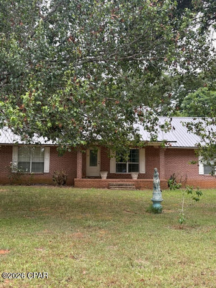 Exceptional multi-family horse farm estate on 20 acres offering versatility, income potential, and endless possibilities. The main residence is a 3BR/2BA brick home featuring a split-bedroom floor plan and over 2,200 sq ft of living space. Recent updates include new appliances (2025), HVAC, and water heater, with metal roofs replaced in 2019. Kitchen includes a gas stove that can be converted back to electric if desired.
The property is fully equipped for agricultural or business use with 4 septic systems and 2 wells. Step outside to a stunning 36x20 custom covered koi pond (3,000 gallons) with dual waterfalls--perfect for relaxing and entertaining.
Equestrian facilities include a 40x100 horse barn with 7 stalls, tack room, feed room, and bathroom, plus an attached powered workshop/storage area and additional open shop space. A 19x73 lean-to houses a sawmill (negotiable). The land is fully fenced and cross-fenced into 5 pastures, all with water access, plus 2 chicken coops. Additional structures include a 20x12 metal building (office) with power and phone, and a 12x36 pole barn with RV hookups. The property is beautifully landscaped with mature oaks and a variety of fruit trees including peach, apricot, apple, pear, fig, chestnut, mulberry, and banana.  Also included is a 2007 double-wide mobile home (4BR/2BA, 2,200+ sq ft) with split floor plan, wood-burning fireplace, and spacious kitchen/dining combo. This home sits on its own 10.33-acre parcel and may be purchased separately. An additional 2006 single-wide (3BR/2BA, 1,100+ sq ft) is negotiable and can remain or be removed prior to closing.
Prime location on Hwy 231 (4-lane) with easy access north to Montgomery and south to Panama City, and just across from Hwy 73 into Marianna. Ideal for a family compound, horse boarding operation, or commercial venture.