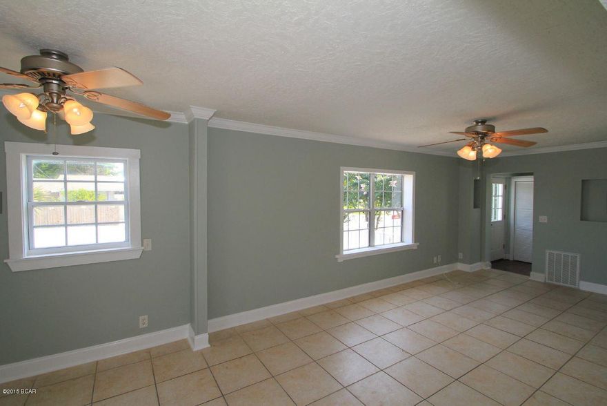 Flexible lease term, 7 months - 1 year. This is a spacious 3 bedroom, 2 bathroom home in the heart of Panama City Beach within a short walk to the beaches. The home features ceramic tile flooring throughout the living areas and kitchen. Entering the home you have the main living room and dining as well as a huge laundry room. The kitchen was recently updated and provides plenty of cabinet storage, counter space, pantry and newer appliances. The back of the home has all 3 bedrooms with carpet and 2 bathrooms. From two of the bedrooms there are entry doors to the massive screened in porch and fenced back yard. This is truly a great find and centrally located to Pier Park, grocery, and restaurants. **Pets negotiable with $250 pet fee**