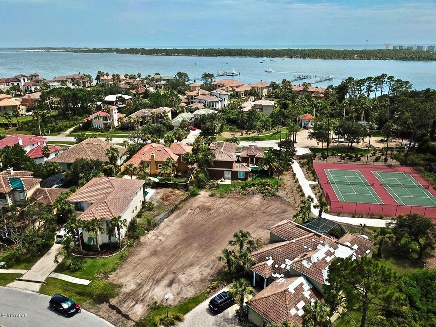 PRICE REDUCED! Vacant lot ready for you to build your dream home in the exclusive gated community of Finisterre! The owner has recently spent $30,000 having the lot cleared and two feet of fill dirt brought in, saving the buyer time and money during the building process. This lot is located on a quite cul-de-sac and in close proximity to the neighborhood amenities including a dock, tennis courts, basketball court and playground.  Finisterre is a small gated community on the east end of Panama City Beach. It is located close to Lighthouse Marina, several restaurants and a short boat ride to Shell Island.