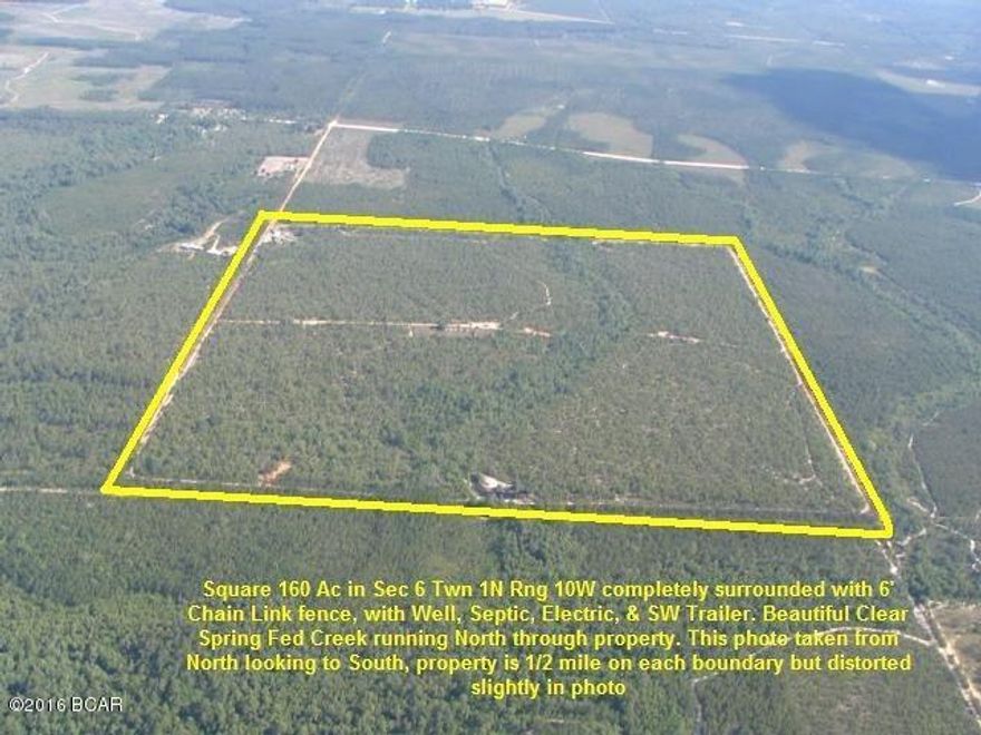 A 160 Acre Square 1/4 Section completely enclosed by 6' Chain Link Fence. Mostly flat land with scrub oaks and sandy soil. A pretty little Clear Creek runs from the South to the North in the middle of this property, and feeds a Pond on the Northern Boundary. Electricity is run to a couple of sites on this property, there are two Wells, and a Septic System in place. An older Mobile Home is at gate which has been vacant for several years, but appears to be habitable. Great opportunity to pick-up 160 acres for recreational property at a great price of approx $ 1,250 per acre. This property is in NorthWestern Calhoun County in NorthWest Florida, approx. 30 minutes South of Interstate 10 and approx. 45 minutes North of Panama City, Mexico Beach, or Port St Joe on the Beautiful Gulf of Mexico.