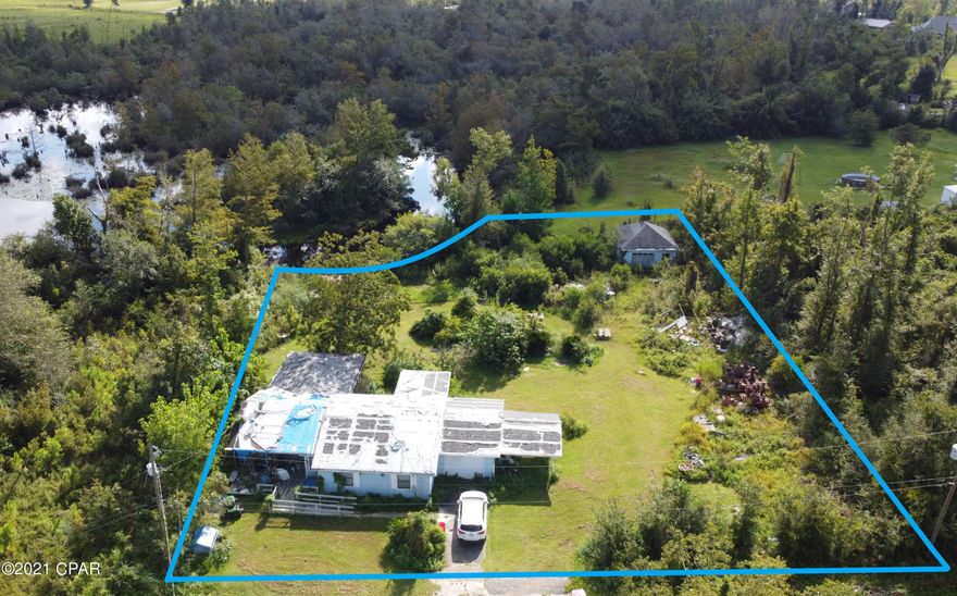 'CURRENTLY UNDER CONTRACT, SELLER ACCEPTING BACKUP OFFERS Incredible opportunity for a builder or investor! Deepwater access to Deerpoint Lake. Nearly .70 of an acre which is actually 2 parcels both 75ft on the street. A home and concrete dock on one side and the other has a Detached garage. Home needs a new roof, decking, and ceilings but is currently occupied. Home needs work to be restored to what it was before Michael but plenty of potential. Could sell one lot and rehab the home or have one huge parcel as currently utilized. This 3/2 has a great layout, a fireplace, bonus space of the master and nice florida room. Great location, nice and quiet area and just minutes to everything. Take a ski boat or fishing boat to the main lake and enjoy all that Deerpoint Lake has