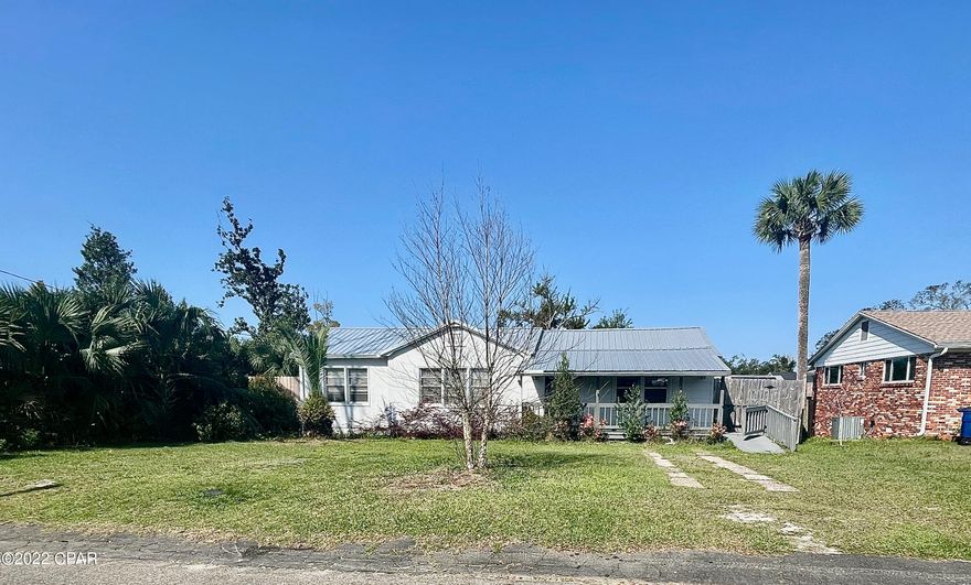 A beautiful cove bungalow, beautifully updated for modern living, the effective built date for the house is 2014!! You'll love the wide, covered front porch, the two car port/Garage and the awesome workshop & storage room with sub electric box, the deep privacy fenced 1/4 acre lot w/ alley access & sliding gate, and 12x18 screened back porch (could be enclosed for additional living space). Inside is a modern split bedroom floor plan, gorgeous original hardwood flooring, and new fixtures & ceiling fans and  one year old AC. The eat-in kitchen has stainless appliances, granite countertops, pantry, & laundry closet Gas stove, tankless gas water-heater. Master suite boasts cathedral ceiling, ga