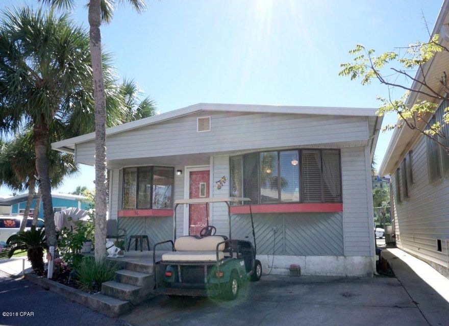 THIS BEAUTIFUL 3 BEDROOM HOME IS NEWLY REMODELED WITH FRESH PAINT AND NEW FURNISHINGS. THE HOME HAS A GREAT OPEN FLOORPLAN WITH MAINTENCE FREE LAMINATE FLOORING IN MOST ROOMS. BONUS ROOM HAS NEW CARPETING. JUST BRING YOUR TOOTHBRUSH AND MOVE IN.  VENTURE OUT IS A GOLF CART COMMUNITY THAT HAS 300' ON THE BEAUTIFUL PRISTINE BEACHES OF THE GULF OF MEXICO AND 1,000' ON THE GRAND LAGOON. VENTURE OUT HAS A LAGOON SIDE (HEATED) POOL AND A BEACHSIDE POOL, FISHING PIER, BOAT RAMP, SHUFFLEBOARD, TENNIS, PICKLEBALL, MINI GOLF, PAVILLION, PICNIC AREA WITH GRILL, PLAYGROUND AND BASKETBALL COURT. VENTURE OUT IS A GATED SECURE COMMUNITY WITH 24/7 SECURITY.