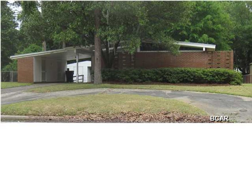 Updates include new roof and updated electrical circuit breaker box and priced to sell! This three bedroom, two bath home very centrally located off 23rd Street is literally minutes to shopping, schools and restaurants! This home has TONS of CURB APPEAL and has been lovingly maintained by one family. Located on a large lot with a circular drive, fenced in back yard and workshop/storage shed lawn pump with irrigation system and storm shutters. Nice private courtyard area and extra exterior storage in the carport. Inside also has LOTS of storage. Great room features an exposed brick wall. This home will not last long! Schedule an appointment to see it today before it is snatched up. All information contained herein is intended to be correct; however, buyer assumes complete