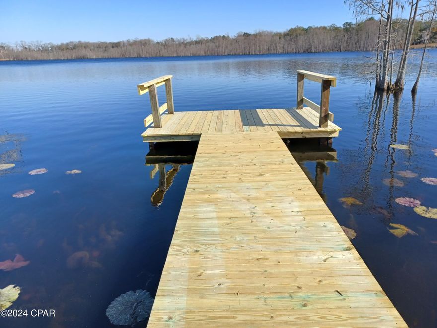 110 acres lakefront property, over 3800 feet of waterfront and 1400 feet of State Road 79 frontage. Residential and commercial possibilites. One hour from Panama City Beach. Approximately 80 acres upland. Sand Hammock Lake is approximately 175 acres and is spring fed.  A portion of the property was platted into 24 lots some years ago and is recorded in Holmes County. Property could be developed into a waterfront subdivision, an RV park, or kept as a private retreat with approximately 3800 feet of waterfront on Sand Hammock Lake. Existing  double wide trailer conveys, but is given no value.