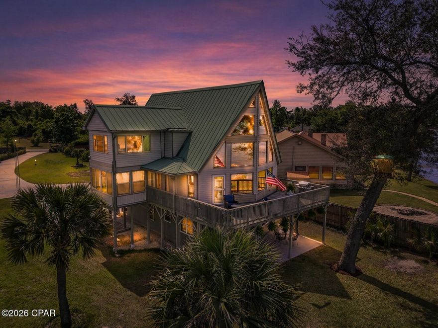 Rare Lakefront Opportunity with Stunning Sunset Views on Deerpoint Lake! Welcome to your dream lakehouse--this custom-built 3-bedroom, 2-bath home on the expansive waters of Deerpoint Lake offers breathtaking sunset-facing views and the ultimate waterfront lifestyle. Imagine your days filled with relaxation and recreation--taking in panoramic lake views through floor-to-ceiling windows, entertaining on your spacious open deck, unwinding on the screened-in porch, watching various wildlife such as the ospreys and bald eagles, and enjoying direct water access from your private boat launch. Whether it's boating, kayaking, jet skiing, or fishing right from your seawall, this property is designed for lake living at its finest. Inside, the home features a bright and airy open-concept living space with abundant natural light, a well-appointed kitchen with custom cabinetry and a convenient breakfast bar, and charming details like rustic beams and pickled pine accent walls that create true lakehouse character. A large loft/bonus room provides flexible space for guests, a game room, or additional living area. Step outside to enjoy multiple outdoor living spaces, including a covered patio, screened porch, and expansive deck, all overlooking the water. The property also offers a large fenced yard, workshop, shed, carport, and an additional detached double carport--perfect for storing all your lake toys. An irrigation system adds convenience, and two public boat ramps are located less than a mile away. Ideally situated near Garner's Supermarket and Dollar General, and just a short drive to Publix, Ascension Sacred Heart, and Tyndall Air Force Base, this home offers both privacy and convenience. Whether you're hosting friends and family or enjoying peaceful evenings under the stars, this exceptional property truly delivers the best of waterfront living. Don't miss this incredible opportunity--schedule your private showing today!