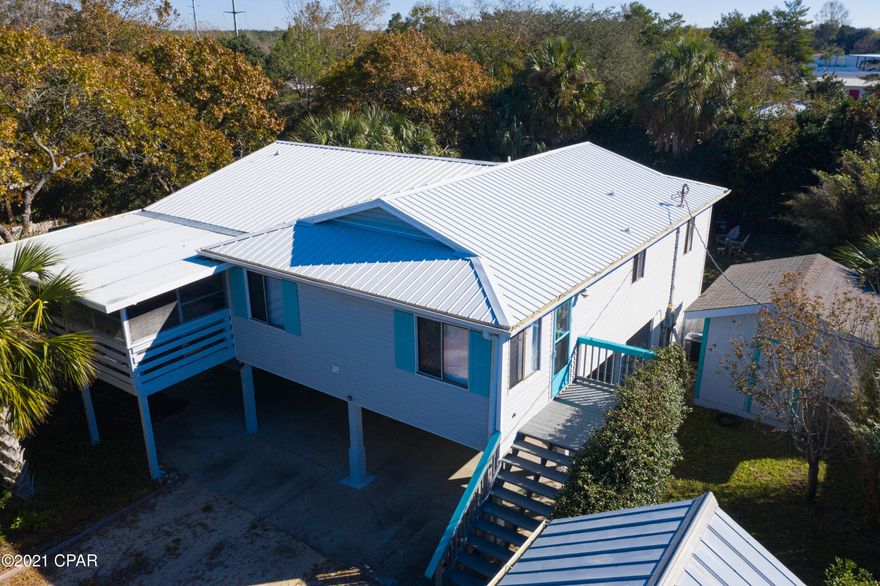 CURRENTLY UNDER CONTRACT, SELLER ACCEPTING BACKUP OFFERS. West end of PCB beach house! 4 bedroom, 3 bath home with workshop/storage shed, covered space for your boat AND a pool! Great Value in the Laguna Beach area that would serve as primary residence, rental or your beach getaway.  NO HOA. Short drive to the beach, Pier Park and conservation trails makes the location unbeatable! New Roof in 2019. New Water Heaters in 2020. Most major appliances only a few years old. Turn key with downstairs ''studio'' bedroom with private entrance.  Measurements approximate, please verify.