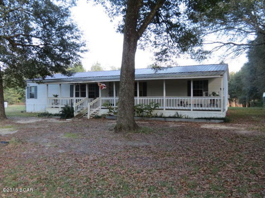 Country, Country, Country, This 3/2 DWMH offers a split floor plan, large living room, kitchen/dining combination, a family room with a fireplace, a large master bedroom with bath. Front porch and a back porch with addition. There is a small concrete yard storage building in the back yard, stocked fish pond in the back of the property, that was stocked by the present owner with bream and other perch. A deer stand is constructed on the back of the lot and owner states that there are a multitude of wild game in the area. All sitting on 3.38 ac. Call for your appointment today!!
