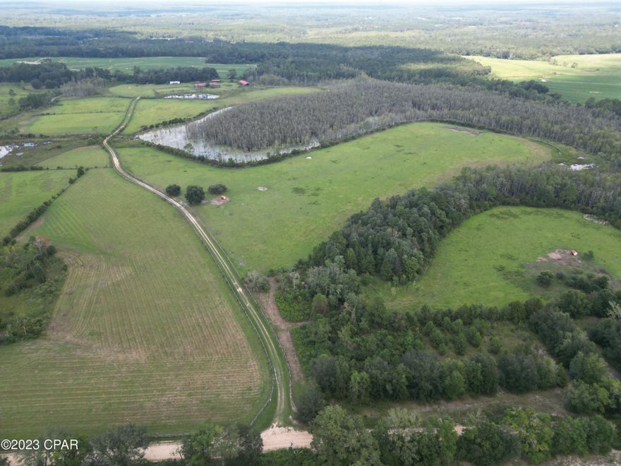 Welcome to Backroads Ranch, with possible owner financing. This 182 acre property, located in the Florida Panhandle, offers the next potential owner the opportunity to revive a once thriving equestrian homestead.  The cattle and horse ranch infrastructure, currently in place, provides all the necessities for a complete working compound.  Equestrian amenities include a 15 stall (38.5' X 121') center-aisle barn with a spacious tack room, two wash racks, feed room, laundry facility, and bathroom. 
A spacious riding ring and a large 40' X 107' enclosed metal barn, with more than ample storage space for hay and/or equipment, is located next to the horse stable. Two additional structures may be used for housing other farm animals such as hogs or chickens. Both are equipped with water.  A three bedroom, two bath, double wide mobile home (needing some work) is also located on the ranch.  Directly behind the mobile home, is a two car garage with an upstairs apartment.
The acreage is both fenced and cross fenced, providing pasture management flexibility.  Approximately 100 acres are currently planted in Tifton 9 hay.  In addition, there are three wells on the property - making it convenient to provide water for animals at various locations on the property.
A unique mixture of pastures, ponds, and woods has created an abundance of wildlife native to Florida, including turkey and white tail deer.  And a variety of recreational opportunities such as hunting, fishing, four wheeling, and trail riding are right outside your front door.
The Backroads Ranch offers the rare opportunity for those who love privacy, the country lifestyle, and convenience of enjoying the world's most beautiful beaches within an hour's drive.  With expansive pastures and ample space for grazing, this is truly any horse and/or cattle owner's dream! Don't miss out on this opportunity to own this extraordinary ranch property!  Call today for a private showing.

Additional information:
*12 paddocks
*endless recreational opportunities
*fenced
*two additional small animal barns - including chicken coop and swine farrow (finish production facility)
*Great hunting opportunities!
*3 wells on property
*44 miles to Dothan, AL
*50 miles to Panama City Beach
*45 miles to Northwest Florida Beaches International Airpot