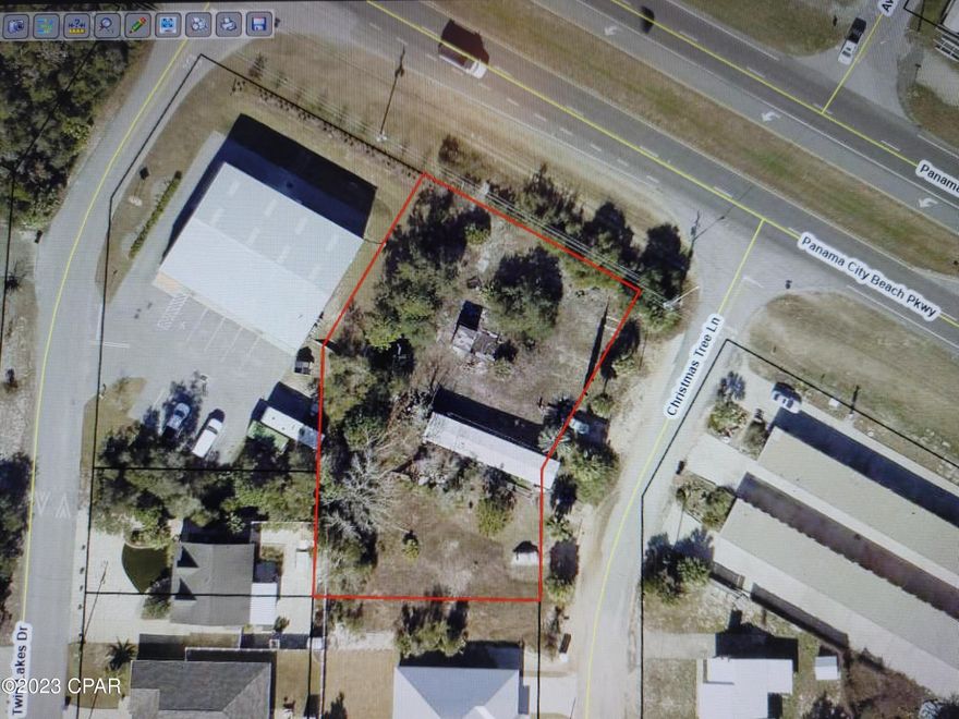CURRENTLY UNDER CONTRACT, SELLER WILL CONSIDER BACKUP OFFERS. Great corner lot with easy access from Hwy 98 (Panama City Beach Pkwy) for commercial possibilities. This .5 acre lot is in a fast growing part of Panama City Beach.  The property has a mobile home that will be removed prior to closing and no value is assigned to that. Property address is on Christmas Tree Lane, but the side of the property runs along Panama City Beach Pkwy with great exposure for your business location. New turn lane off of Panama City Beach Pkwy onto Christmas Tree Lane has been added, so this will be a great benefit to any business location.