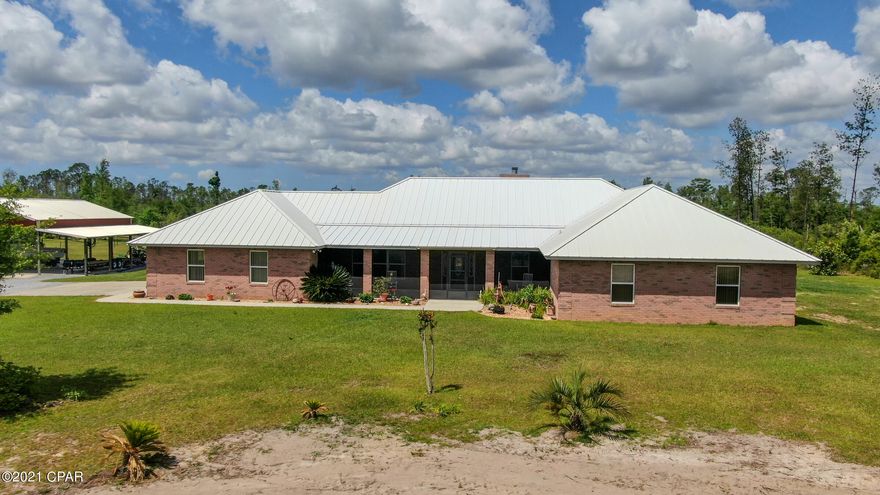 Ready to make the move to your own private paradise? This is your opportunity to enjoy peace and quiet on 20 acres of land. This spacious CUSTOM BUILT, all brick home is move-in ready. Inside you'll find 3 bedrooms,   Including a separate MASTER SUITE with over sized closet and nice private  bathroom. Other features include: BEAUTIFUL water proof LUXURY PLANK flooring , convenient laundry room and lots of living space. The DREAM KITCHEN offers double ovens , 2 ISLANDS and custom kitchen cabinetry with ample storage space. An adjoining FAMILY ROOM has high ceilings and a lovely fireplace.  The outside space features a Caged POOL, whole house GENERATOR, pole barn with boat storage and extra parking.  Don't miss this opportunity to call this peaceful oasis your very own!