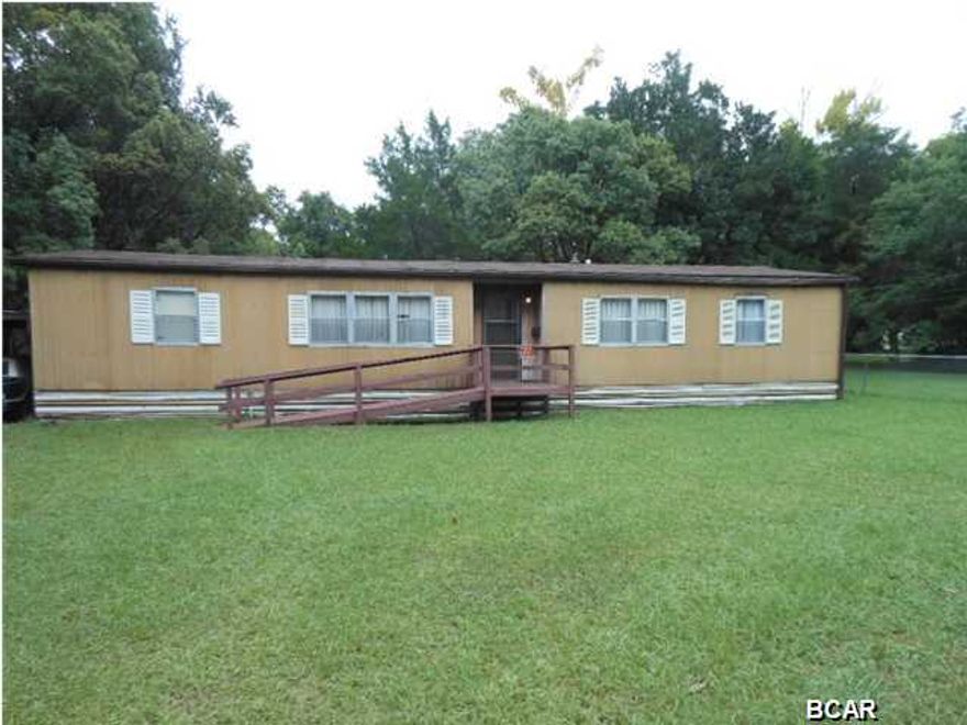 CONGRATULATIONS! By reading this you now have the opportunity to purchase a double wide mobile home AND an EXTRA LOT in PARKER !! Bring your tools and fix this low priced home up to be just perfect for you and your family. There is an extra lot that goes with this sale give you a total of 123 feet by 114 feet lot size. Tons of room for the family and the dog !! Located in the heart of Parker, and just a couple blocks off of Tyndall Parkway and close to the base and all the stores on the east side. There is additional, adjoining land with a house, a single wide mobile home, and a garage apartment that fronts 11th Street also available, but is NOT included in this sale. Ask your Realtor to check into it for you. It is MLS #624707. Sorry, there is NO OWNER FINANCING available.