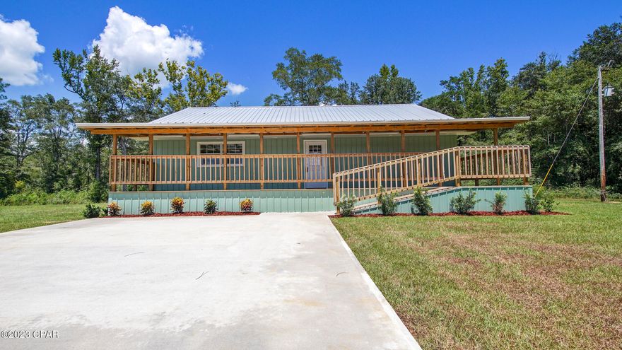 Welcome to paradise in the heart of the Florida Panhandle! This incredible 3-bedroom, 2 1/2-bath home rests on a sprawling 3-acre canvas of natural beauty. Prepare to be captivated by the meticulous craftsmanship and thoughtful design that permeates every inch of this residence. A complete remodel has transformed this property into a modern haven, where no detail has been overlooked.

The exterior stands as a testament to quality and style, featuring a mint metal siding and a durable metal roof that promises years of worry-free living. The 42' x 8' covered front porch invites you to relax and soak in the tranquility of your surroundings, providing the perfect spot to enjoy your morning coffee or host gatherings with friends and family.

Step inside to discover a world of elegance and comfort. The open-concept layout seamlessly connects the living spaces, creating a sense of flow and unity. Brand-new vinyl plank flooring adds a touch of sophistication while ensuring low maintenance living. The kitchen gleams with modernity, boasting new stainless steel appliances that make culinary endeavors a true pleasure. The combination of new drywall, insulation, and HVAC guarantees a comfortable and energy-efficient atmosphere year-round. To top it off, there is a massive 41x13 upstairs bonus room with a half bath, that could easily be an additional bedroom.... Or two!

Located on a paved road, this property offers both convenience and seclusion. And for those seeking the allure of the coastline, you're in luck! Less than an hour's drive separates you from the pristine shores of Panama City Beach. Whether it's a day of lounging by the ocean or enjoying the vibrant coastal culture, the possibilities are endless.

This home isn't just a dwelling; it's a testament to the potential of a life well-lived. With its top-notch renovations, picturesque setting, and proximity to both urban amenities and natural wonders, this property encapsulates the very essence of Florida Panhandle living. Don't miss the chance to make this amazing 3-bedroom, 2 1/2-bath home your own slice of paradise. Contact us today to arrange a viewing and experience the magic for yourself!