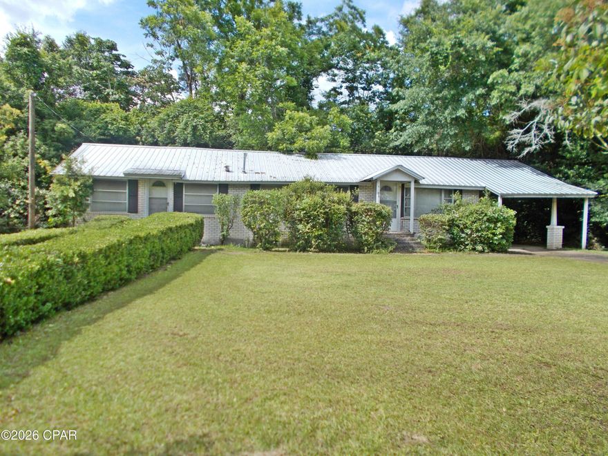 4/2 Brick home in the city limits, needs some TLC would be ideal to flip or live in. Large living room, family room dining room and kitchen. 4 bedrooms and a carport. Not easy to find at this price. There is a new gas water heater installed this year.