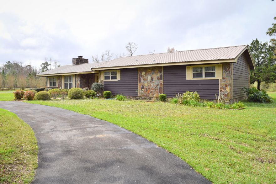 Boasting numerous breathing taking views this 47+/- acre farm has been pridefully maintained over the years and it shows. The 3-bedroom 3-bath country home features a spacious living area with wood burning fireplace, open kitchen/dining area, large laundry room, an office that could be converted to a 4th bedroom, master suite with double vanity and an additional master suite located on the opposite side of the home with walk-in closet and gas burning fireplace. Outside you will find an attached carport, covered rear porch, luscious landscaping, cat fish pond, numerous detached buildings including a 44x20 workshop with roll up door, open pole barn with lean-too and enclosed welding shop. Most of the property has been row cropped o Property is located approximately 10 minutes from Interstate 10 and a short drive to Panama City Beach.