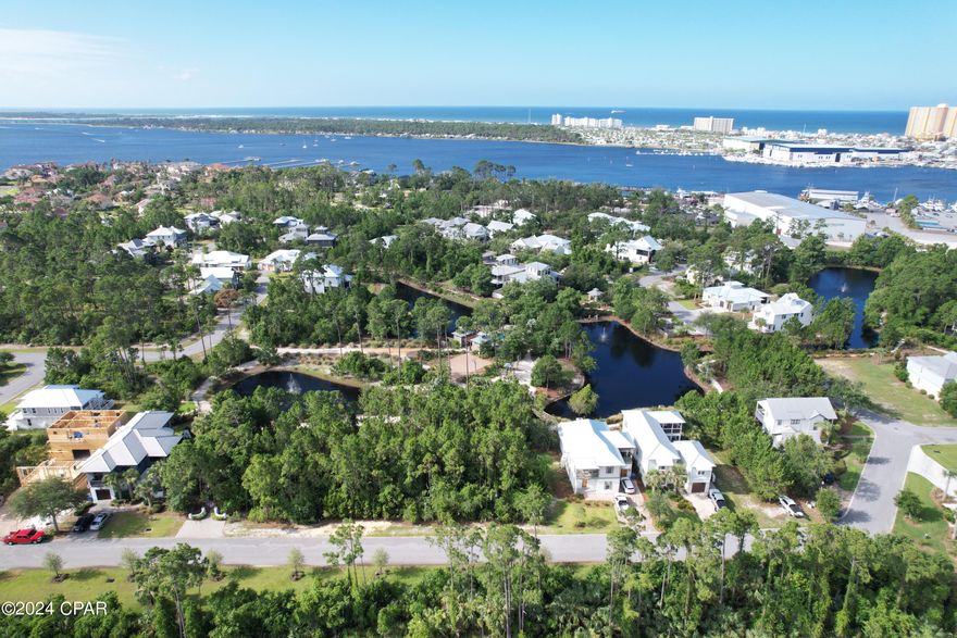 One of the most private lots in the beautiful Martinique subdivision! This lot backs up to the pond and a trail with walking access to the community amenities, making it the perfect central location to build your dream home. Amenities include a basketball court, pool, walking trails, and playground. Martinique is a gated community and is tucked away off Thomas Drive within short distance to the white sand beaches, many popular restaurants, and quick access to Hwy 98. Buyer to verify all measurements, building restrictions, and any information deemed important.