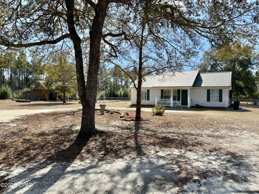 Escape to your own slice of country living with this 3-bedroom, 2-bath home situated on over 10 private acres in peaceful Southport. Built in 2002, this property offers 1,092 square feet of living space surrounded by wide-open land, mature trees, and endless potential.

While the home does need some TLC and cosmetic updates, it presents a fantastic opportunity for buyers looking to add their personal touch and build equity.

A standout feature of the property is the 36x16 barn, perfect for livestock, equipment storage, workshop space, or hobby use. With plenty of cleared land, there's ample room for gardening, animals, recreational vehicles, or even future expansion.

Conveniently located with easy access to Hwy 77, local schools, and Panama City amenities, this property offers the ideal blend of rural charm and accessibility.

If you're looking for space, privacy, and potential, this country property is ready for its next chapter.
