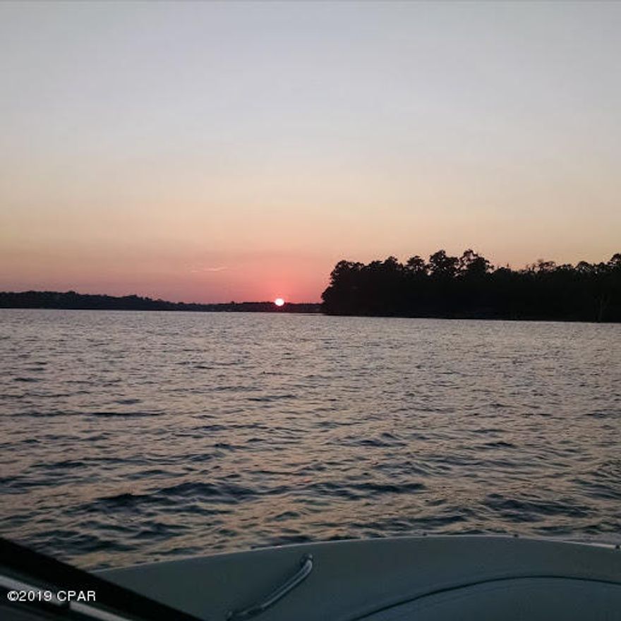 Property under contract however seller is accepting back up offers.   This unique property has so much to offer.  Once you pull up in the circular drive and enter the house, your eyes will be drawn to the picture size windows on the back of the house and the relaxing waterfront view of Deer point lake. This two story house has been updated with tile floors, new carpet, roof and paint.   As you enter the house on the left is the perfect area for your den or office.  As you enter the great room, note the gas fireplace and staircase to the upstairs.   The dining area is perfect for your cookout with family and friends. note the kitchen features stainless steel appliances to include two ovens, upgraded refrigerator,  breakfast bar, granite counter tops and a tile back splash The kitchen is a chef's dream.  One of the master suites is located private deck to enjoy the sunsets.  Upstairs you will find another master suite complete with an over sized bathroom and enjoy your private balcony overlooking the lake.  Don't forget the other two upstair bedrooms which are supported by a bath.  This house is perfect for entertaining as you have a game room, hobby/craft room perfect for model airplanes, railroad or sewing  and for those overnight guests,mother in law or teenager there is  a complete apartment to include a kitchenette and full bath with a Jacuzzi style tub.     Afternoons may be enjoyed in the lake room which is a enclosed deck just steps away from the lake, lower your boat in your private boathouse, which provides you a gateway to skiing, boating and fishing.  Enjoy watching the sunset from your private deck.   Don't forget the extra yard storage building, surround sound wiring and sprinkler system.   This is a property that must be toured in order to really appreciate the many features that will help you escape as you come home.  Call today for your private tour.  All information contained herein is believed to be accurate and true however it is the buyers complete responsibility for verification of all information.