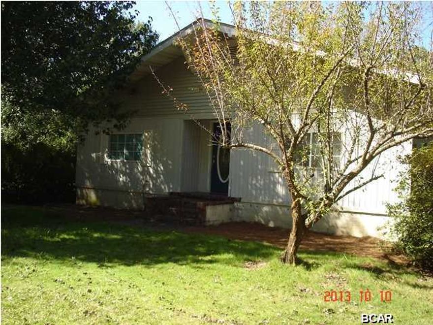 ....Bank approved short sale at $78,000 (buyer couldn't get financing) It sits on a beautiful wooded corner lot. Home was built in the Cove in 1950 and moved to current location in 1990 and seller had new electrical/plumbing updated and insulation installed. New a/c unit in 2004, new roof in 1996. The home features 9 foot ceilings throughout with special feature on the ceiling in the dining room (see photos). Loads of cabinets in the kitchen with an huge island bar. Hardwood floors. ceiling fans in all bedrooms, bonus room, living room and dining room. Tile in foyer, bonus room and kitchen. Vinyl in one of the bathrooms and kitchen. . What was once a porch is now an additional bonus room (current owners used as 3rd bedroom) and Bath with Whirlpool, Separate Shower, and Closet. Deck