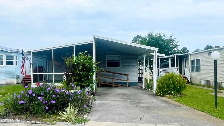 Buyer must be 55 or older and occupy the home. This is a beautiful, well-kept, quiet 55 + community in the heart of Panama City Beach. This community provides easy access to all Panama City Beach has to offer, but tucked away off the beaten path. The community features a heated/cool pool, clubhouse and a private street (with no through traffic)! Golf cart friendly and fun friendly! The HOA covers water, trash, sewer, basic cable, irrigation and the pool and clubhouse usage! The home comes furnished with living room, dining and bedroom furnishing. Fresh paint throughout. New floors. Brand new kitchen and bathrooms! Cabinets feature soft close doors, lazy Suzanne, pull out shelves, built in trash and contemporary finishes! All appliances stay including the washer and dryer! The home features a large, screened in porch facing the street with sliding glass doors to the main living space. Open concept home with living room, kitchen and dining space in the front of the home and two bedrooms and two bathrooms at the back of the home. There are (2) sheds in the backyard, one with electricity for a workshop. There are motion sensor lights all around and two ramps to access the front and side doors!