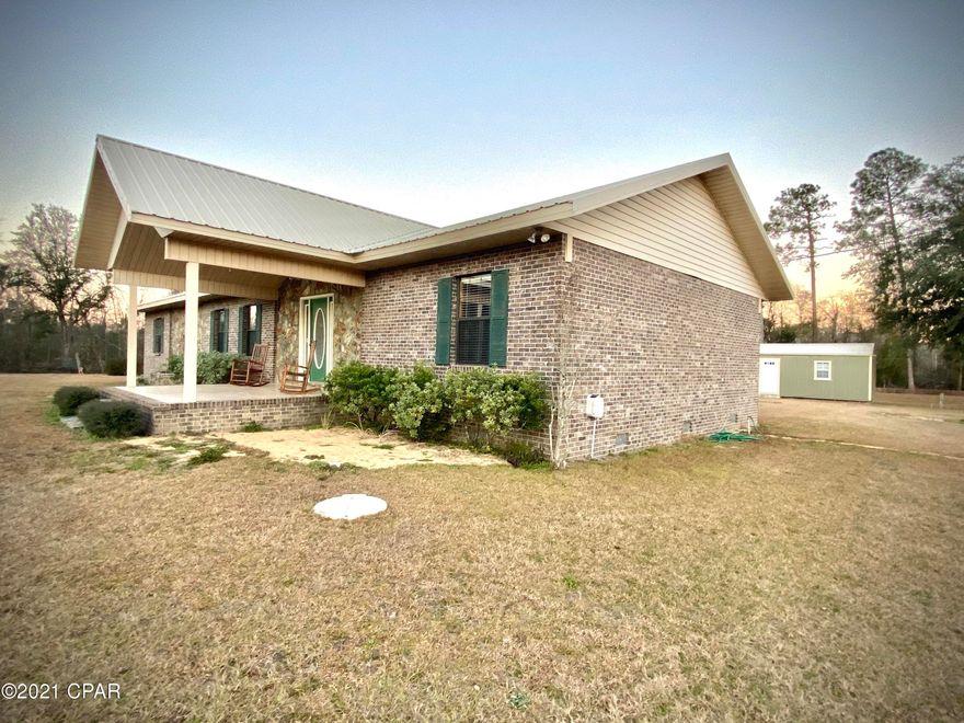 Welcome yourself home every day to unwind in this immaculately maintained 2658 sq ft, 3 bed, 2 bath country home situated on a beautiful 2.43 acre lot in Grand Ridge. Pull your car into the garage and then snuggle up next to the crackling fire in the Buck Stove, sip a glass of tea on the front porch as the sun sets, or take a nap in the screened open-air living room. However you like to unwind, the 1798 sq ft of centrally heated and cooled living space or the 428 sq ft of outdoor living space is sure to accommodate.  The  master suite is well-appointed with a large closet in the bedroom and sprawling walk-in closet in the bathroom. The walk-in closets in the other two bedrooms exceed expectations as well.  The out building is a blank slate for storage, man-cave, or she-shed. Make it yours!