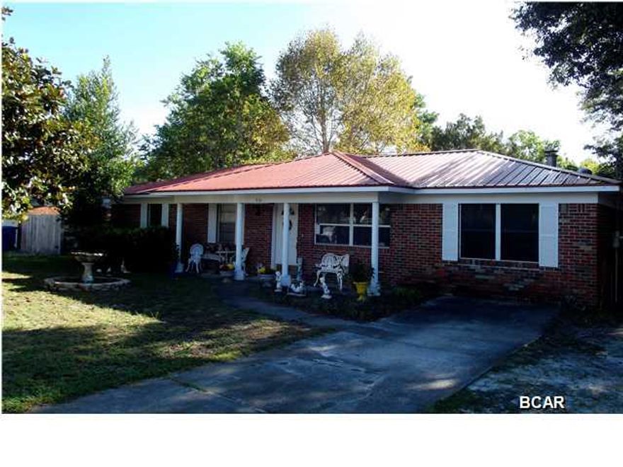 BRAND NEW METAL ROOF!! This Seller is Motivated! Great price for this updated home close to Tyndall AFB. The seller recently added Pergo flooring, replaced the bathroom vanities, toilets, shower and added tile. For more energy efficiency the seller had extra insulation blown into the attic, new thermal windows, and new water heater. There is a wood burning fireplace in the family room along with built-in shelves perfect for your personal library. Storage will never be an issue as not only is there lots of space and shelving in the utility room, there is a shed in the backyard. There is also a 24x12 workshop perfect for the handyman/craftsman and it does have power. The home is also under a termite repair bond. If you have kids and pets, you'll feel comfortable knowing they have a